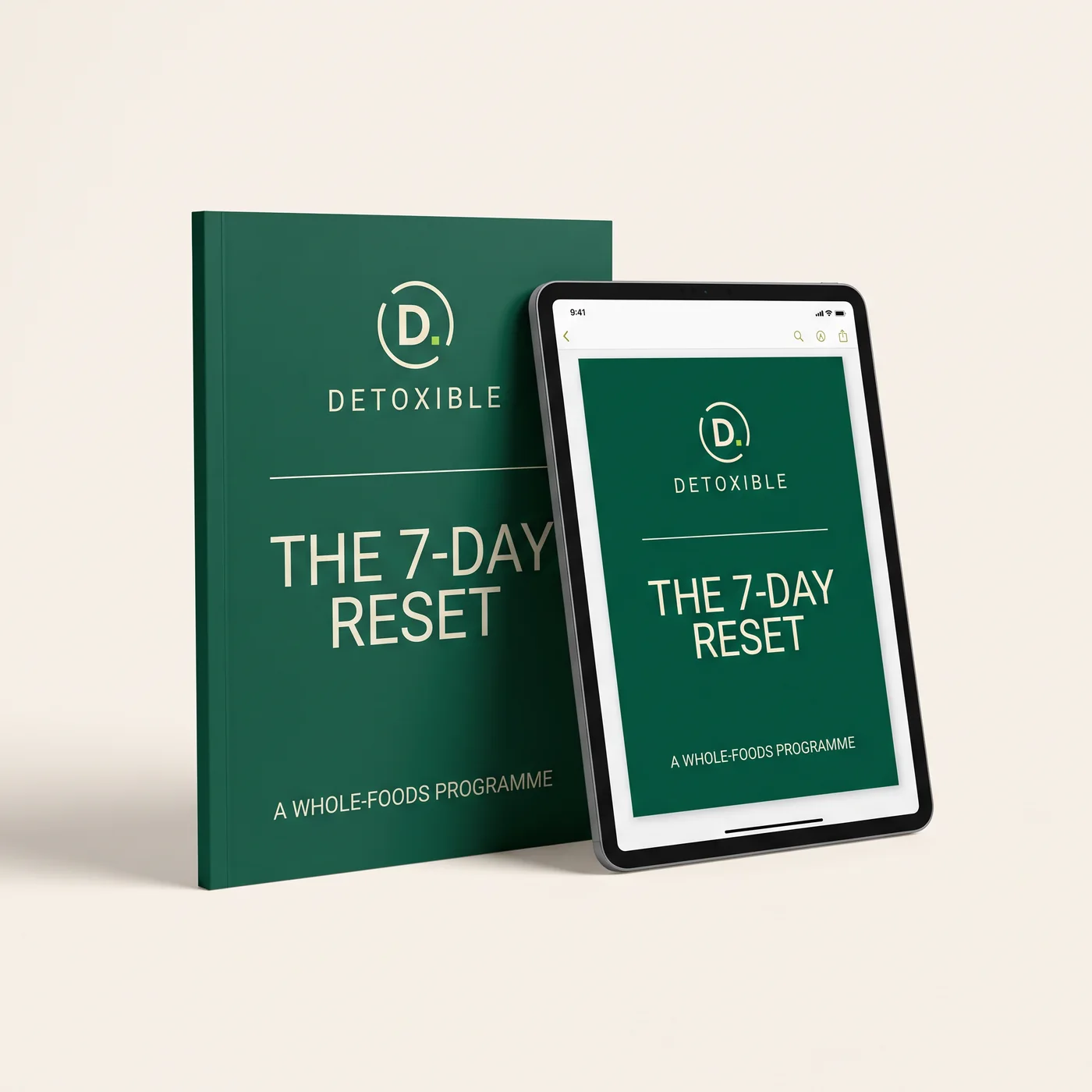 The 7-Day Reset: a dark green Detoxible-branded book stood beside a tablet showing the same cover